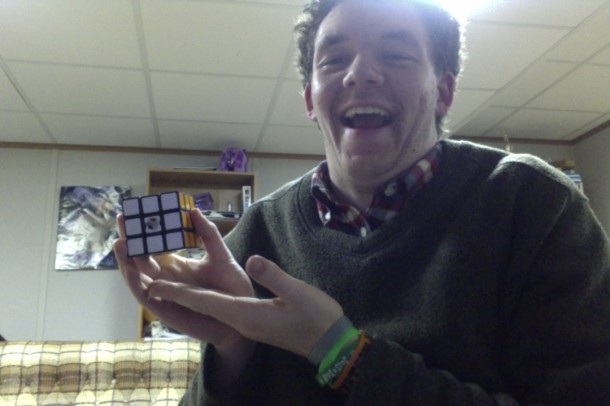 Scott "Scopher" Sinnickson poses with one of his Rubik's Cubes, after solving it in under a minute