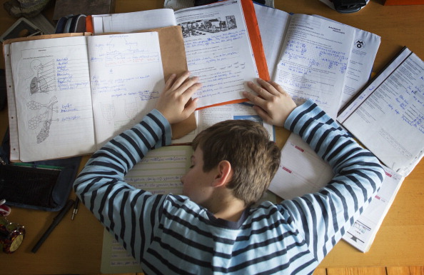 BERLIN, GERMANY - OCTOBER 27: A staged photo of a boy having fallen asleep at his desk whilst doing homework as pictured on October 27, 2013 in Berlin, Germany. (Photo by Thomas Koehler/Photothek via Getty Images)