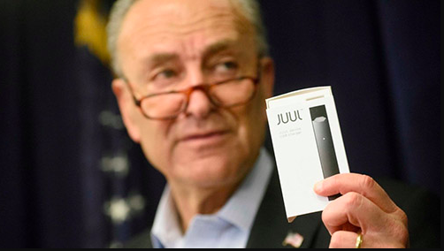 Senator Chuck E. Schumer holds a Juul e-cigarette package 