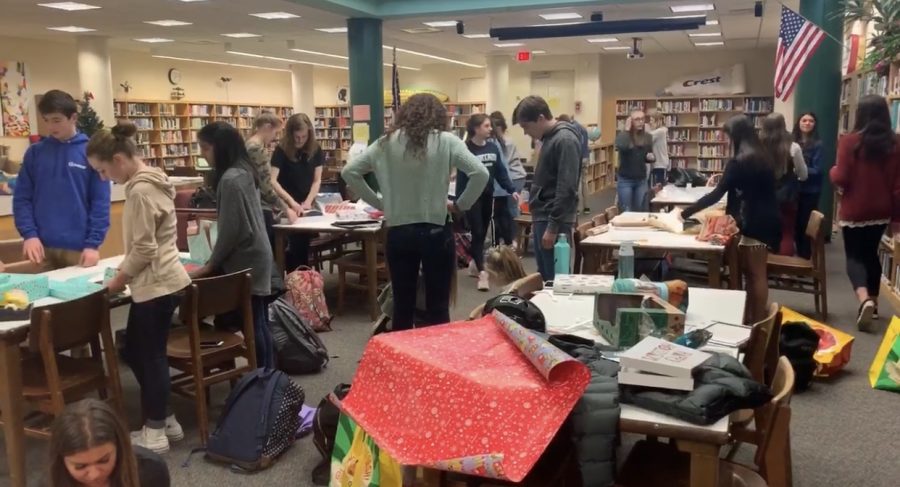Student government wrapping presents for adopt-a-families.