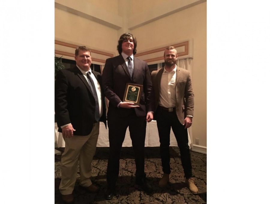 Senior Jon Mendoza (middle), pictured with Coach Schaumloffel (left) and Coach ONeill (right). 