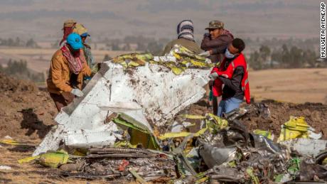 Rescuers work at the scene of an Ethiopian Airlines flight crash near Bishoftu, or Debre Zeit, south of Addis Ababa, Ethiopia, Monday, March 11, 2019. A spokesman says Ethiopian Airlines has grounded all its Boeing 737 Max 8 aircraft as a safety precaution, following the crash of one of its planes in which 157 people were killed. (AP Photo/Mulugeta Ayene)