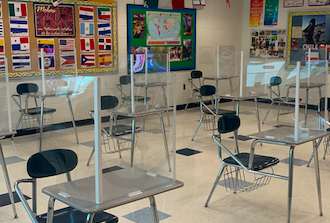 Plexiglass desk dividers shown here in a language classroom.
