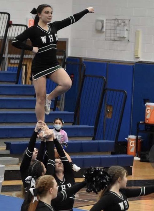 Sofia on top of her cheer squad