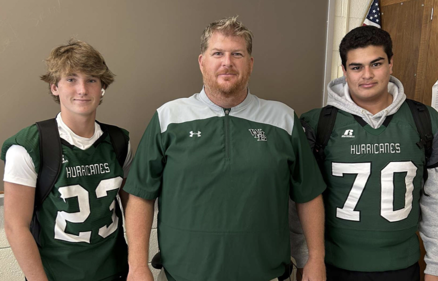 Mr. Schaum with two of his student athletes.