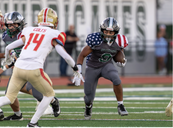 Nic #9 carries the ball against Hills West